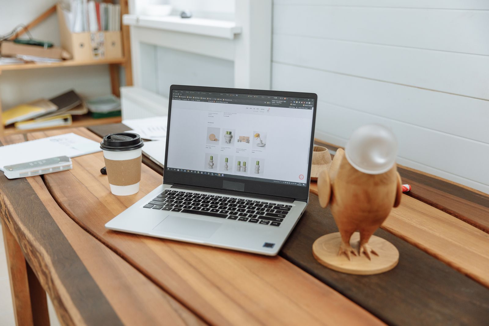Laptop on a desk showing a website design in progress